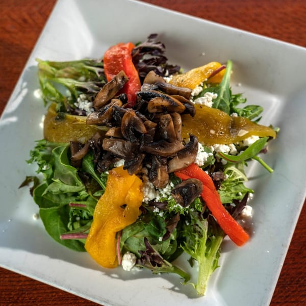 Mama Mia 44SW salad with mixed greens, roasted mushrooms, bell peppers, and feta cheese.